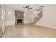Spacious living room with a stone fireplace, hardwood floors, and staircase at 18 Bonnybrook Ct, Selma, NC 27576
