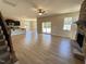 Spacious living room with wood floors, stone fireplace, ceiling fan and sliding doors to the outside at 18 Bonnybrook Ct, Selma, NC 27576