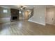 Spacious living room with built-in cabinets, a stone fireplace, wood flooring, and staircase access at 18 Bonnybrook Ct, Selma, NC 27576