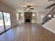 Bright living room features wood floors, a stone fireplace, built-in cabinets, and a staircase at 18 Bonnybrook Ct, Selma, NC 27576