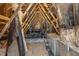 The attic features exposed rafters with insulation and an air conditioning system at 18 S Rowsham Pl, Smithfield, NC 27577