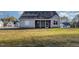 The home's backyard features a green lawn and a partial view of the screened in porch at 18 S Rowsham Pl, Smithfield, NC 27577