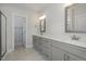 Bathroom featuring double sinks with granite countertops and large framed mirrors at 18 S Rowsham Pl, Smithfield, NC 27577