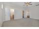Spacious bedroom featuring carpeted flooring, ceiling fan, and access to the Primary bath and walk-in closet at 18 S Rowsham Pl, Smithfield, NC 27577
