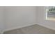 Cozy bedroom with neutral carpet flooring and a large window offering natural light at 18 S Rowsham Pl, Smithfield, NC 27577