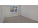 Small bedroom featuring neutral carpet flooring and a bright window view to the exterior at 18 S Rowsham Pl, Smithfield, NC 27577