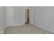 This bedroom features neutral walls and carpet and two white doors, one to a closet and one to the hall at 18 S Rowsham Pl, Smithfield, NC 27577