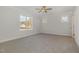 Bright bedroom with large windows allowing for ample natural light and neutral colored carpeted flooring at 18 S Rowsham Pl, Smithfield, NC 27577