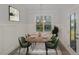 Staged dining room with hardwood floors, wainscoting, and a modern chandelier at 18 S Rowsham Pl, Smithfield, NC 27577