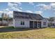 The home's gray exterior features a screened in porch, windows and a yard at 18 S Rowsham Pl, Smithfield, NC 27577