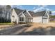 Picture of the home showing the garage, front door, and part of the yard at 18 S Rowsham Pl, Smithfield, NC 27577