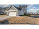 View of the side of the home showing the garage and nice lawn at 18 S Rowsham Pl, Smithfield, NC 27577
