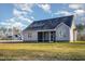 The backyard view of this home shows the screened porch and the home's neutral color scheme at 18 S Rowsham Pl, Smithfield, NC 27577