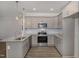Well-lit kitchen featuring stainless steel appliances, granite countertops, and light gray cabinetry at 18 S Rowsham Pl, Smithfield, NC 27577