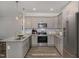 Well-lit kitchen featuring stainless steel appliances, granite countertops, and light gray cabinetry at 18 S Rowsham Pl, Smithfield, NC 27577