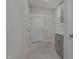 Functional laundry room featuring tile flooring, modern cabinetry, and access to the home's entrance at 18 S Rowsham Pl, Smithfield, NC 27577