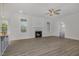 Bright living room with a fireplace, wood floors, and two windows at 18 S Rowsham Pl, Smithfield, NC 27577