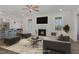 Staged living room with fireplace, wood floors, and lots of natural light at 18 S Rowsham Pl, Smithfield, NC 27577