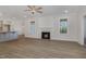 Spacious living room with fireplace, wood floors, and lots of natural light at 18 S Rowsham Pl, Smithfield, NC 27577