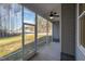 This screened porch features a ceiling fan and a view of the lawn and surrounding neighborhood at 18 S Rowsham Pl, Smithfield, NC 27577