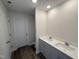 Bathroom featuring a double sink vanity, granite countertop, and wood flooring at 18 W Emily Gardens Dr, Selma, NC 27576