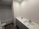 Bathroom with double sink vanity, modern fixtures, and a shower-tub combination for relaxation at 18 W Emily Gardens Dr, Selma, NC 27576