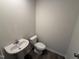 Powder room featuring modern fixtures, and dark wood flooring for added depth at 18 W Emily Gardens Dr, Selma, NC 27576