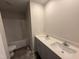 Bathroom featuring double sinks, quartz countertops, and a shower-tub combination at 18 W Emily Gardens Dr, Selma, NC 27576