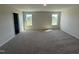 Spacious bedroom with soft carpet, neutral walls, and plenty of natural light streaming through large windows at 18 W Emily Gardens Dr, Selma, NC 27576