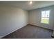 Bedroom featuring neutral walls, carpet flooring, and a window that provides natural light at 18 W Emily Gardens Dr, Selma, NC 27576