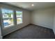 Bright bedroom with carpet flooring, two windows providing outside views and plenty of natural light at 18 W Emily Gardens Dr, Selma, NC 27576