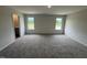 Bright bedroom showcasing plush carpet, a large window, and neutral paint at 18 W Emily Gardens Dr, Selma, NC 27576
