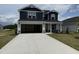 Charming two-story home featuring a spacious driveway and attached two-car garage at 18 W Emily Gardens Dr, Selma, NC 27576