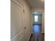 Hallway showcasing the wood flooring with a view of a brightly lit room at 18 W Emily Gardens Dr, Selma, NC 27576