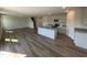 Open-concept kitchen with a gray island, stainless steel appliances, and stylish wood flooring at 18 W Emily Gardens Dr, Selma, NC 27576