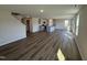 Open-concept living space featuring wood flooring, gray kitchen cabinets, and abundant natural light at 18 W Emily Gardens Dr, Selma, NC 27576
