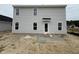 Two-story home backyard featuring a door, concrete patio and several windows at 18 W Emily Gardens Dr, Selma, NC 27577