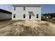 The home's backyard features a simple back door and windows, awaiting landscaping and personalization at 18 W Emily Gardens Dr, Selma, NC 27577