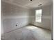 Spacious bedroom with ample natural light streaming through a large window at 18 W Emily Gardens Dr, Selma, NC 27577