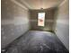 View of a bedroom with one window showing outside the home, ready to be finished at 18 W Emily Gardens Dr, Selma, NC 27577