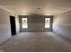 A bedroom under construction with gray walls, white trim, and two windows at 18 W Emily Gardens Dr, Selma, NC 27577