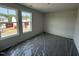 Bright bedroom featuring dual windows offering exterior views, ready for personalization and comfortable living at 18 W Emily Gardens Dr, Selma, NC 27577