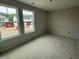 A bedroom featuring lots of natural light from the double windows, great space and neutral color at 18 W Emily Gardens Dr, Selma, NC 27577