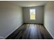 Cozy bedroom with hardwood floors, white walls, base trim and a sunny window at 18 W Emily Gardens Dr, Selma, NC 27576