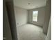 A bright bedroom featuring a neutral color pallete with a single window bringing in natural light at 18 W Emily Gardens Dr, Selma, NC 27577
