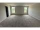 Spacious bedroom featuring plush carpet, and natural light from large windows at 18 W Emily Gardens Dr, Selma, NC 27576