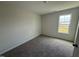 Bright bedroom with a large window, neutral walls, and plush carpet at 18 W Emily Gardens Dr, Selma, NC 27576