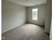 Small bedroom with neutral carpet, white walls, and a window with a view at 18 W Emily Gardens Dr, Selma, NC 27576