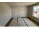 A well-lit bedroom featuring luxury vinyl plank floors, neutral walls, and a window view of the exterior at 18 W Emily Gardens Dr, Selma, NC 27577