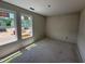 Sunlit bedroom with large windows, offering a view of the neighborhood construction at 18 W Emily Gardens Dr, Selma, NC 27577